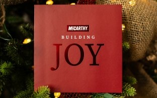 McCarthy-branded holiday card inside a Christmas tree.