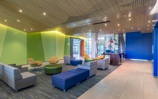 A seating area with colorful couches and chairs