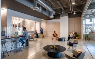 Multiple people sitting in the lounge area of a cafe.